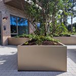 Feature Planter in Pearl Beiged with long curves and modular used to define recreational space