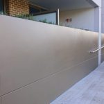 Planter dividing street level wall feature