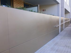 Planter dividing street level wall feature